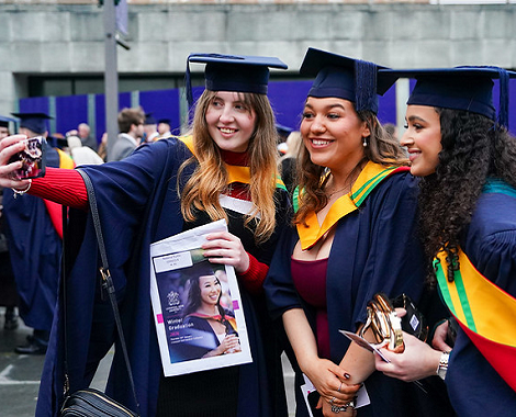 students taking a selfie at graduation